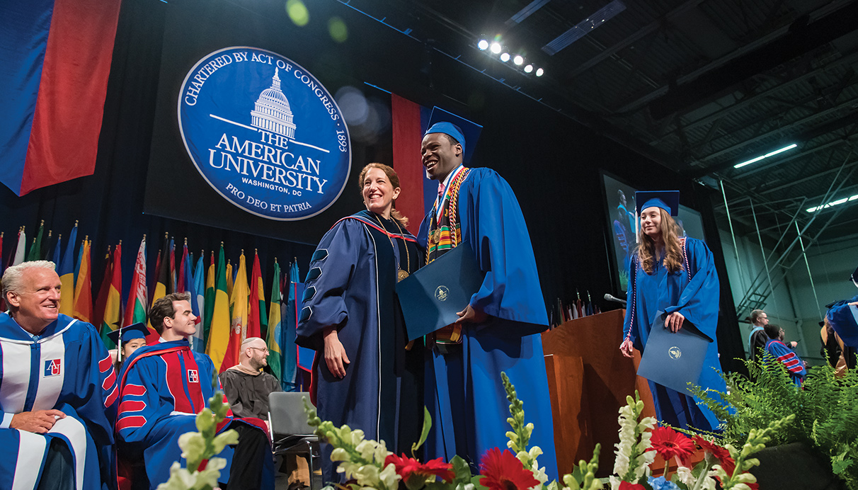 Graduate crosses the stage at Commencement