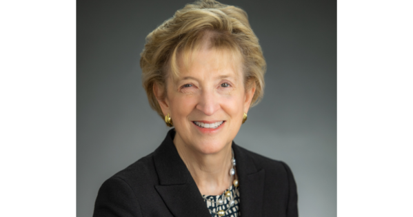 Ann Friedman, AU SOE Alumna and creator of the Planet Word Museum, smiles and wears a black blazer.