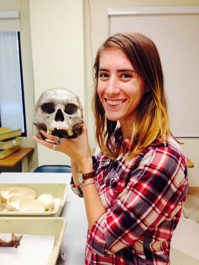 Anthro student in forensic lab with skull.