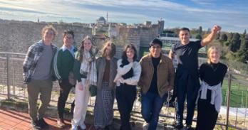 Students on museum rooftop in Istanbul with the city behind