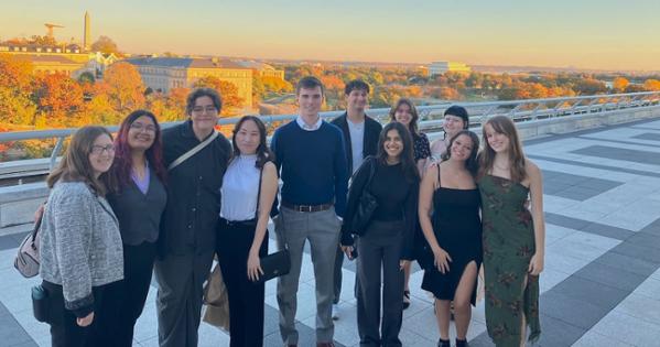 Student tour and concert-goers on the Kennedy Center Terrace with DC view in the background.