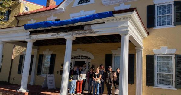 Dodona Manor front porch with tour group