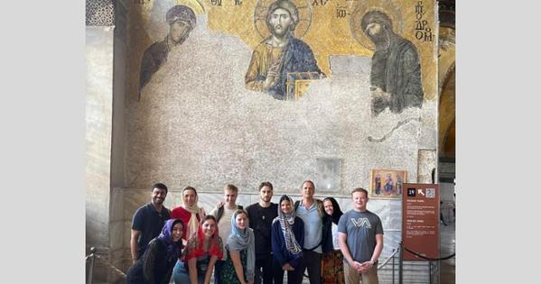 Student tour group in front of a wall fresco in the Hagia Sophia.