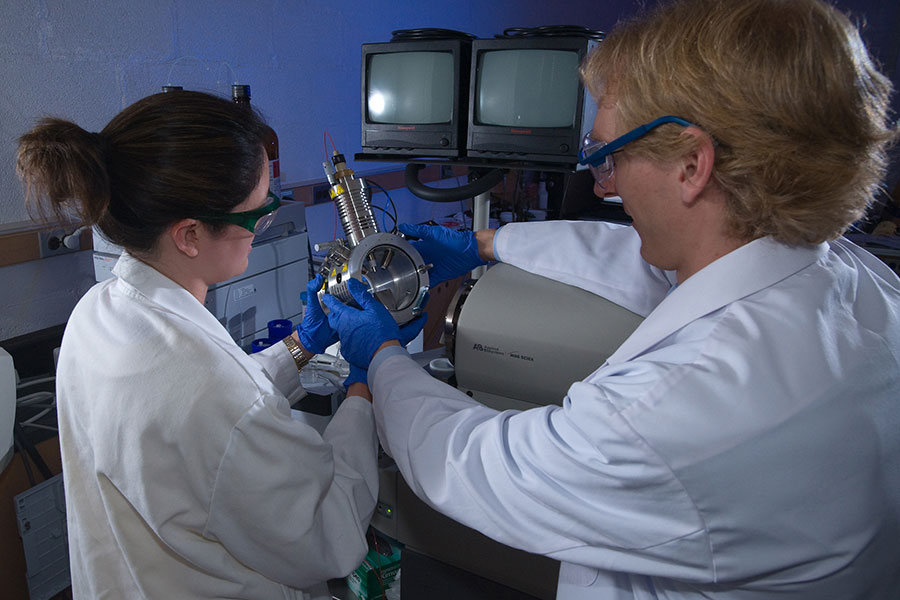 Student and professor work with spectrometer