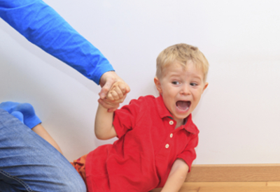 A child pulls away from their parent.