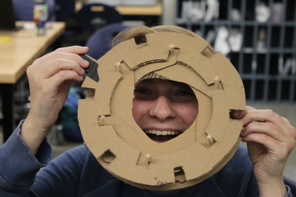 Bex Warner looking through their cardboard aperture