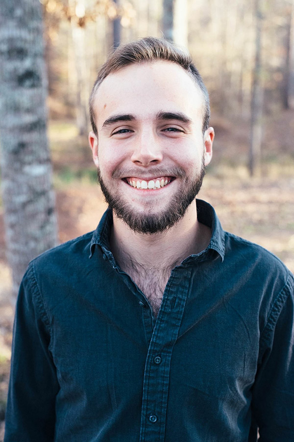 Forrest smiling in the woods