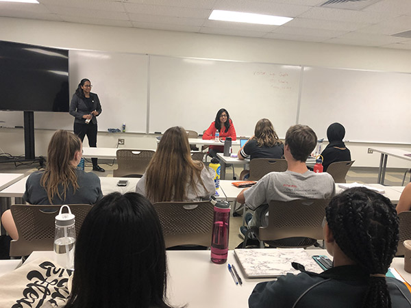 A person presents to students in a classroom