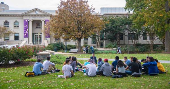 A professor teaches a class on the quad