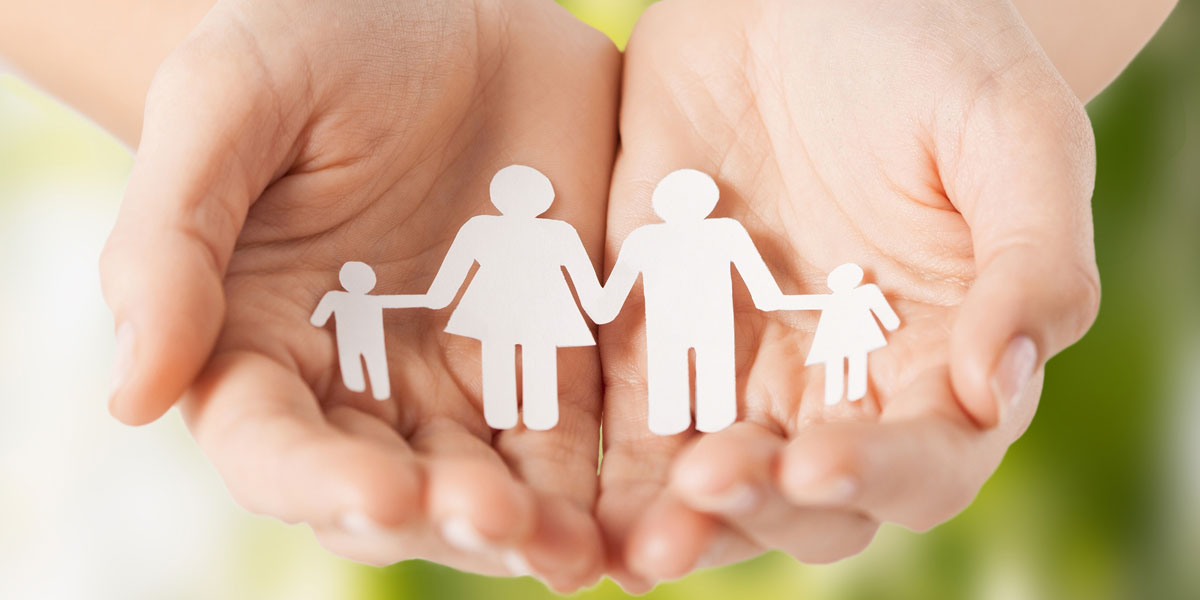 Paper chain of people, cradled in two hands