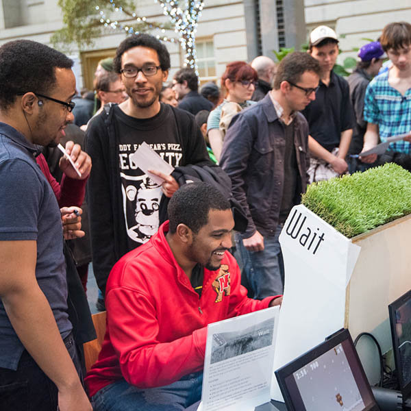 A man plays the game Wait at Indie Arcade event