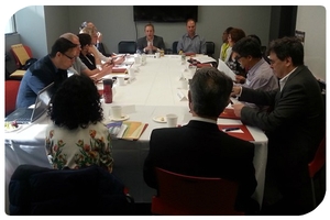 Group of scholars sitting around a large table