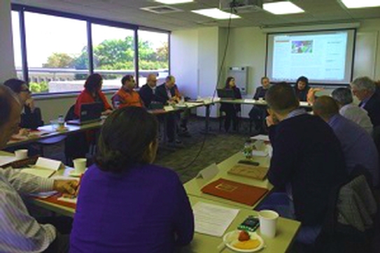 Group sitting around a table during a workshop discusion