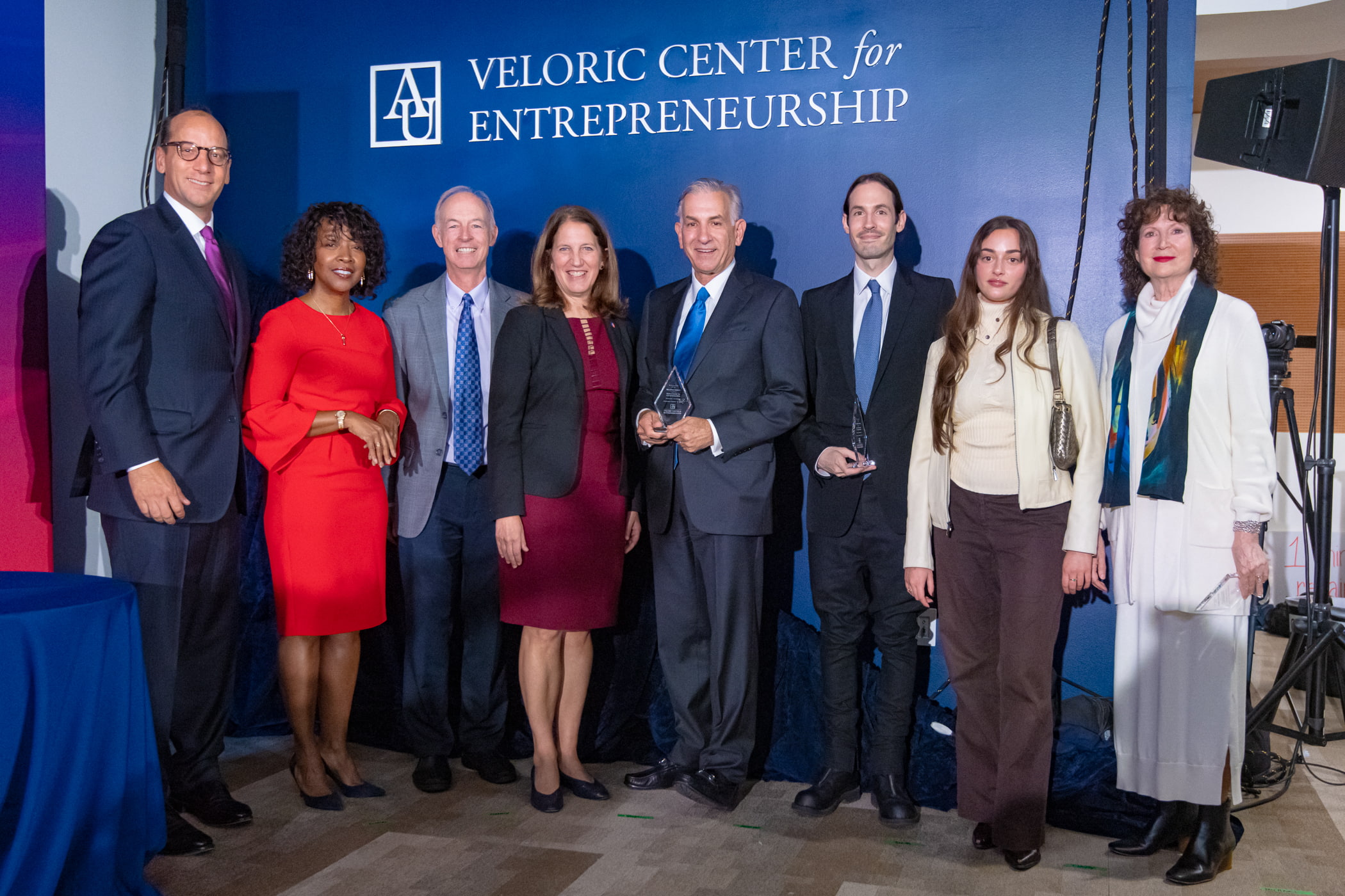 Leadership gathered in front of the Veloric Center for Entrepreneurship lettering.