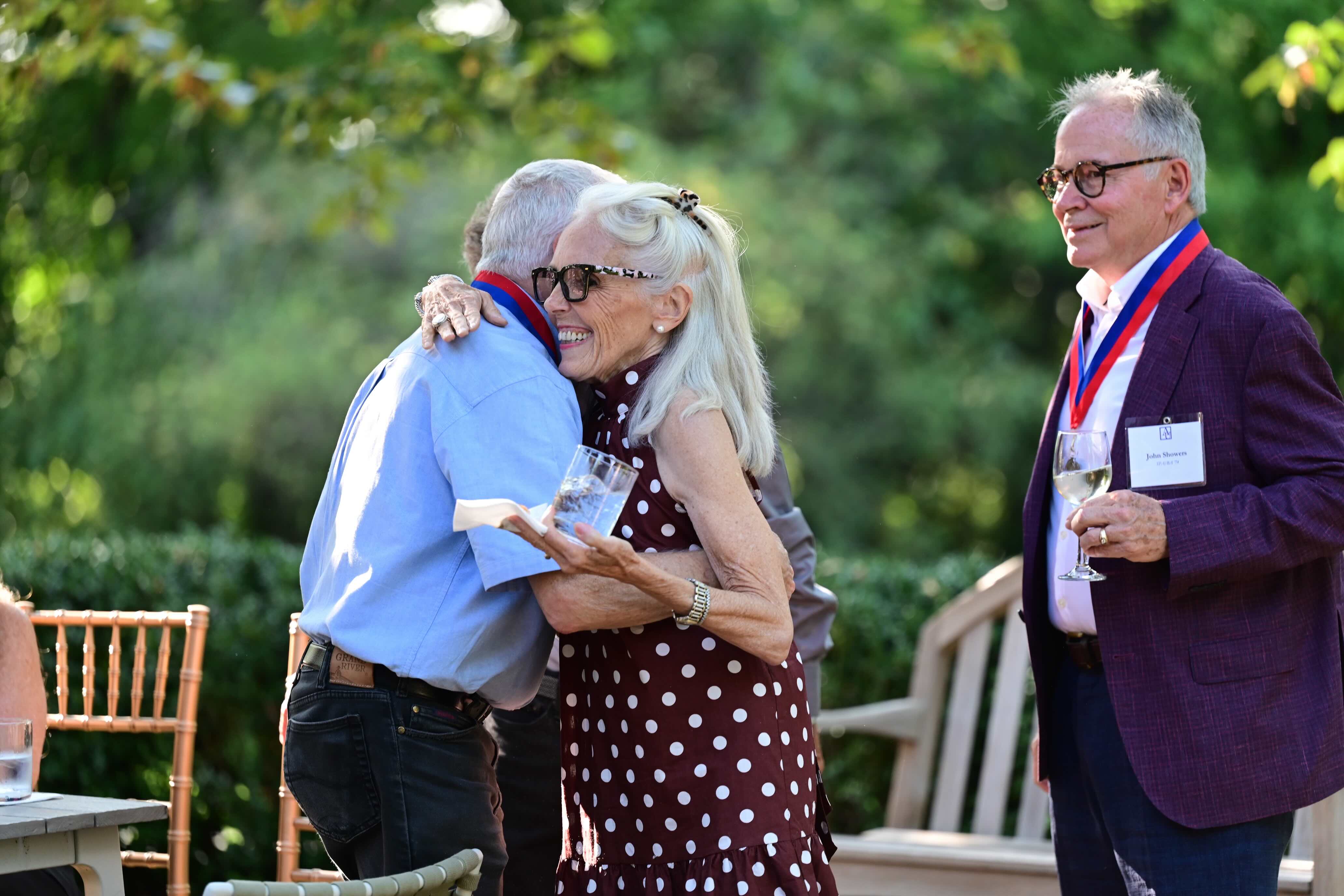 Golden Eagle alumni hugging at the 2024 celebrations