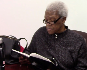 Barbara Smith reading archival material at the HARRC Open House.