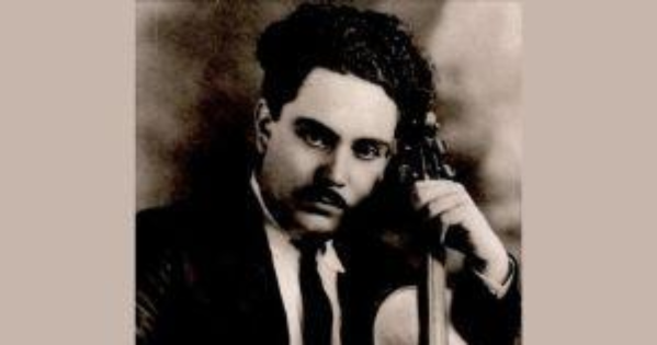 Silvestre Revueltas in jacket and tie holding a violin