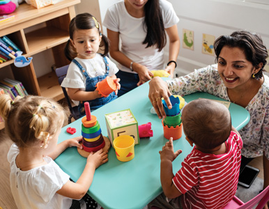 childcare center worker interacts with kids