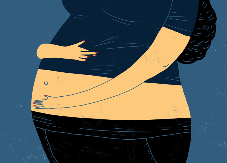 pregnant woman cradling her belly and crossing her fingers