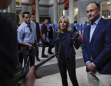 Michael LaRosa stands behind Jill Biden and Doug Emhoff  near press scrum