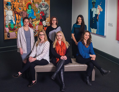 Six AU alumnae pose in a gallery at the National Museum of Some in the Arts in DC