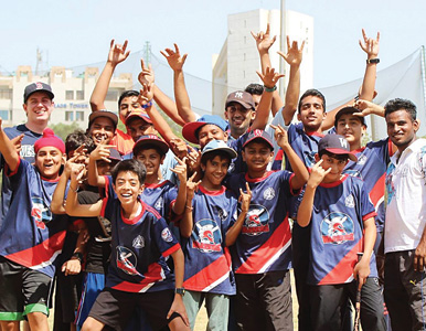 Indian children cheer on the baseball field