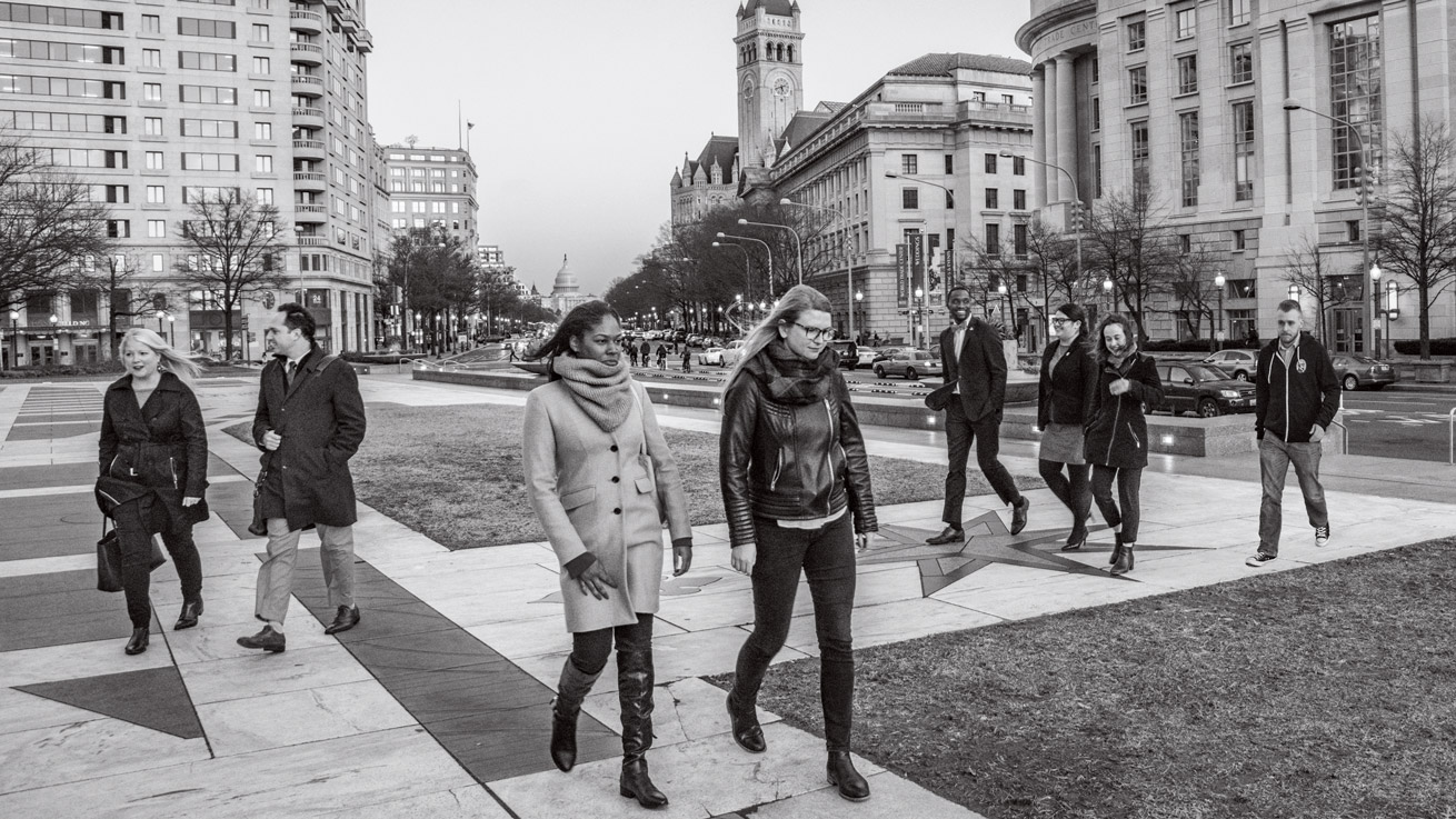 AU alumni and students walk across Freedom Plaza