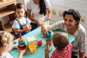 childcare center worker interacts with kids