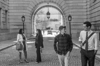 alumni walk around the Reagan building in downtown DC