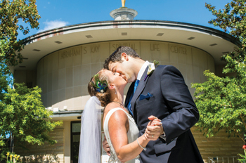 Lisa Suda and Justin Berger in front of Kay on their wedding day