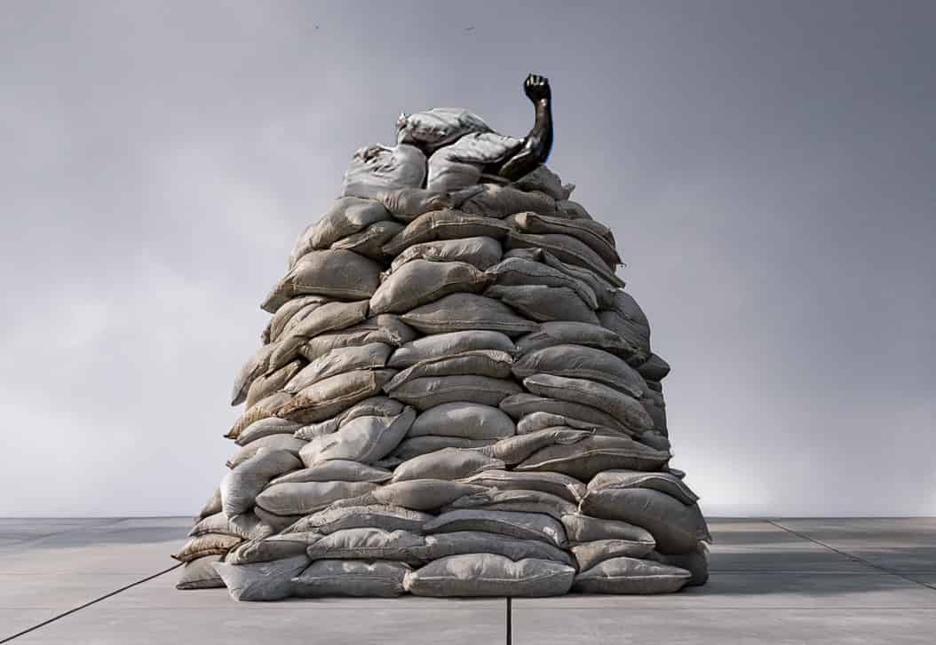 Noel Kassewitz, O'er the ramparts we watched, waiting, 2024. Polypropylene sandbags, interior wood frame, cast resin, 84 inches x 60 inches x 60 inches. Courtesy of the artist.