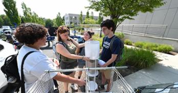 AU students look over the treasures they picked up at Project Move In. Photo by Jeff Watts.