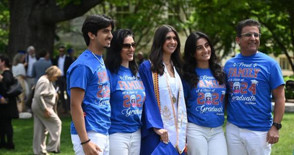 Supporters of an AU graduate wear matching t-shirts. Photo by Jeff Watts. 