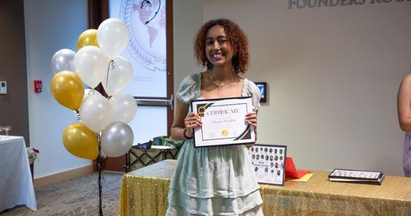 Eliana Menkir shows off her certificate from the STEP closing ceremony. Photo by Julia Gibson.