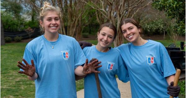 AU women's soccer players pose for a photo after working on a project near their homefield. Photo courtesy of AU Athletics.