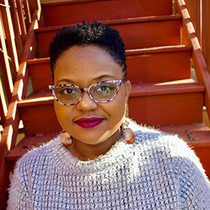 Person wearing glasses sitting on stairs