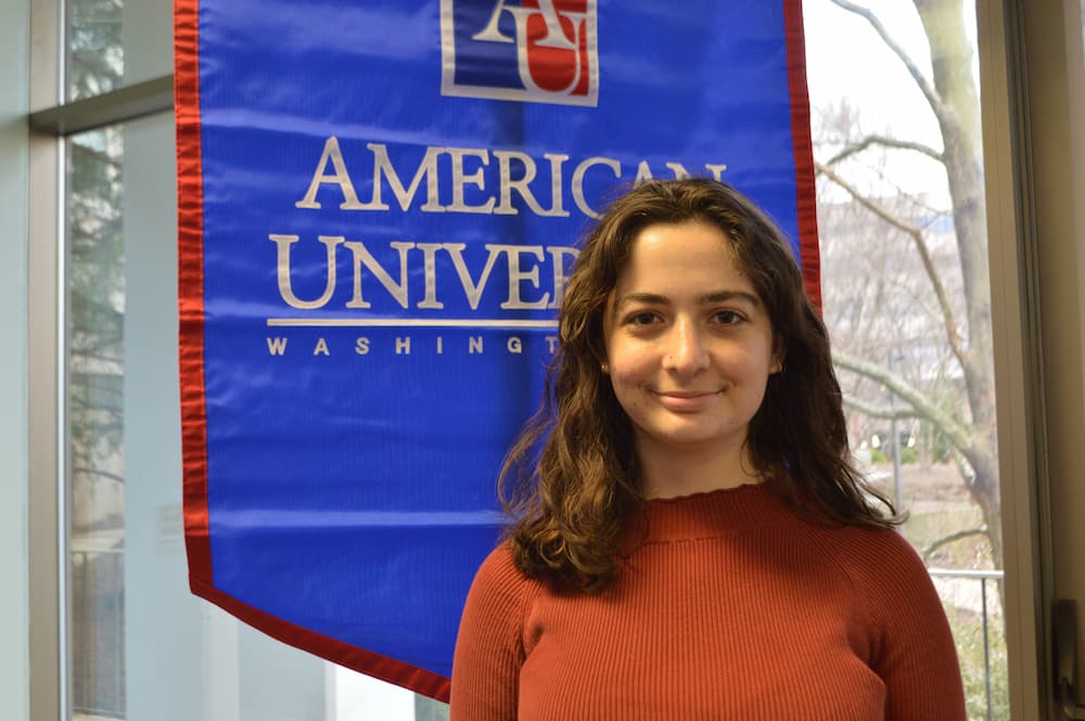 Talia Marshall standing in front of AU banner