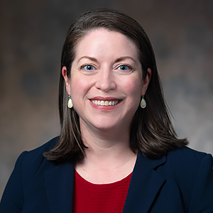 Portrait of Bridget Trogden wearing red shirt and blue jacket