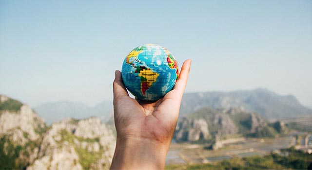 hands holding a small globe