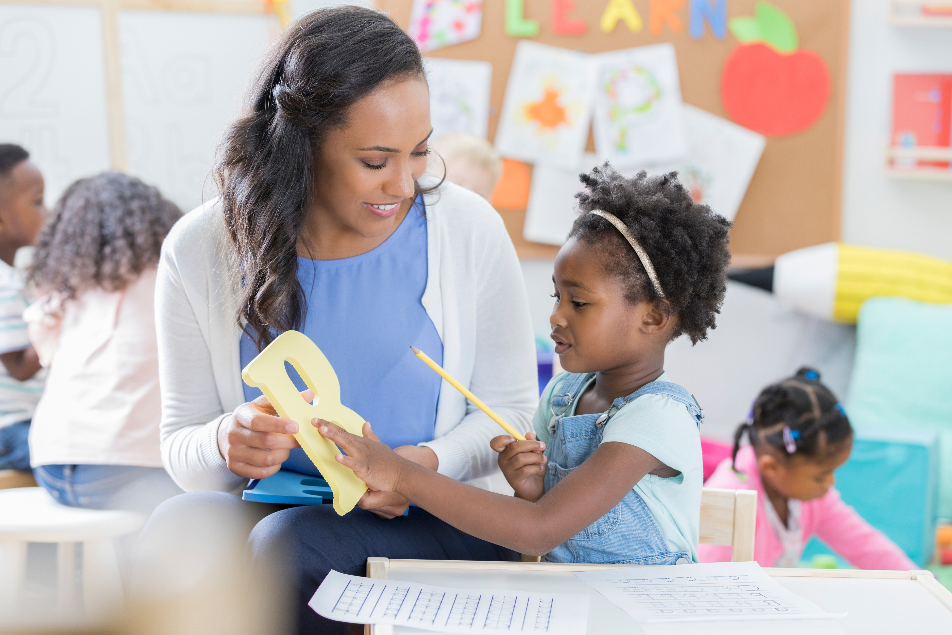 Teacher with child learning to read