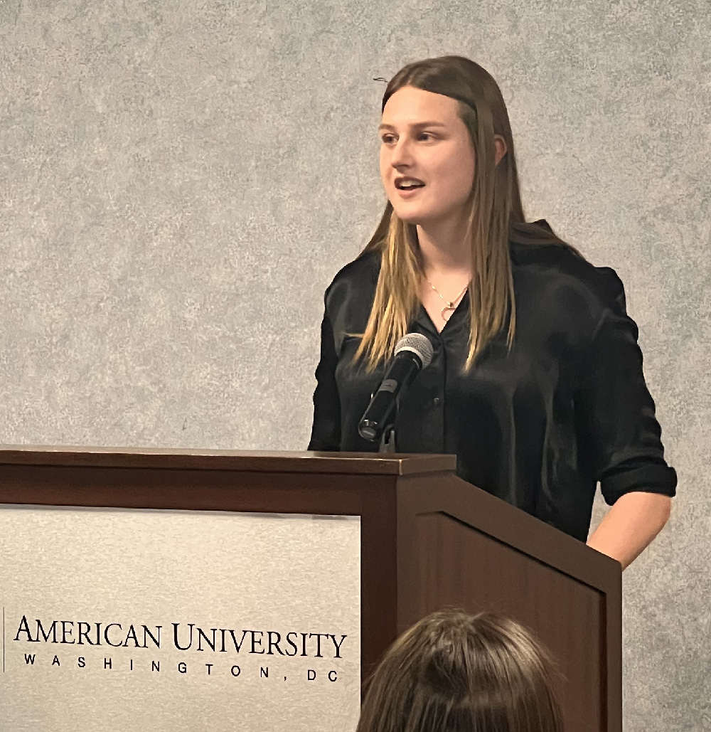 Ella Thompson '23 speaks at the podium.