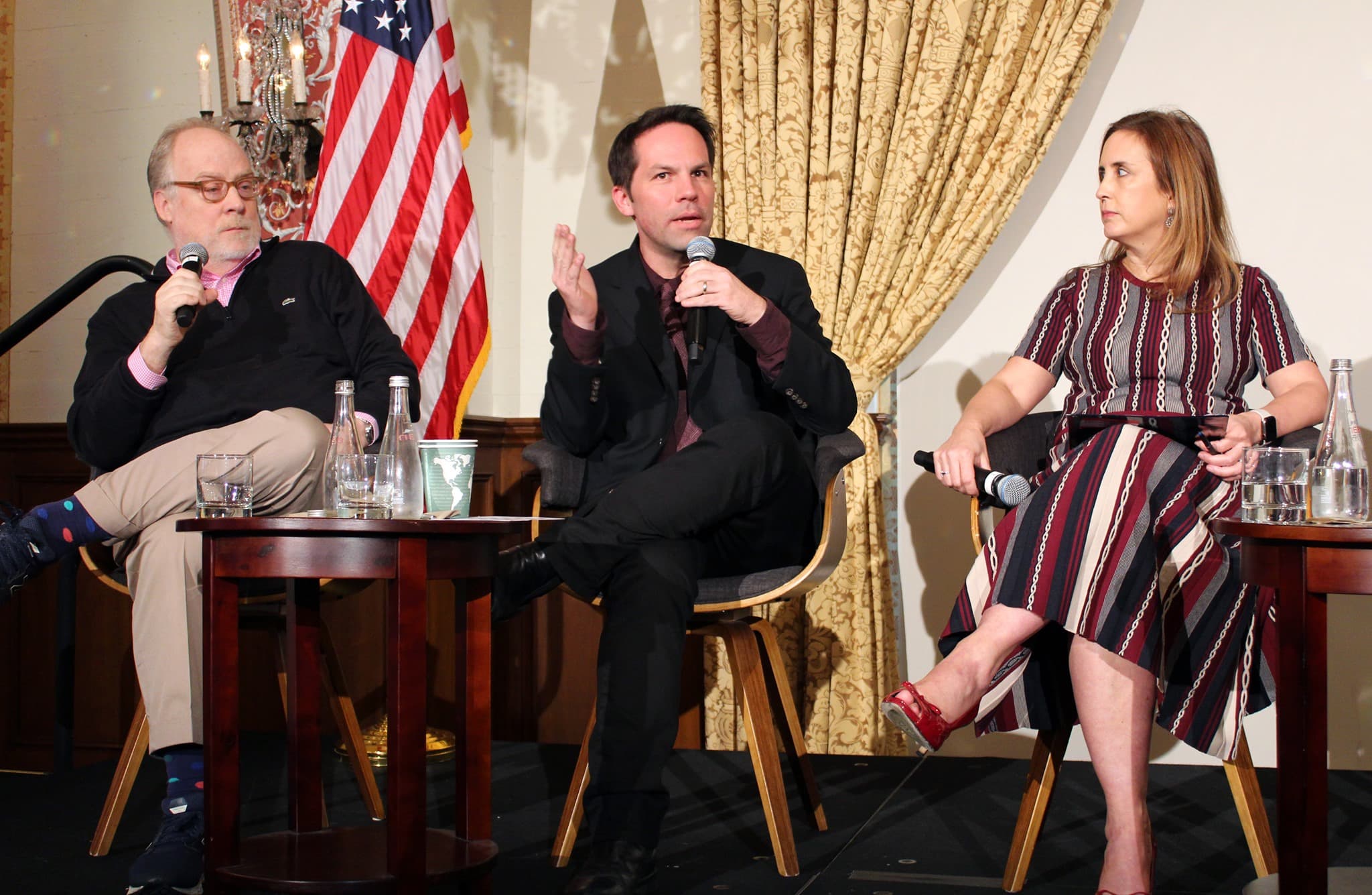 Betsy Fischer Martin, seated far right, with two panelists seated to her left.