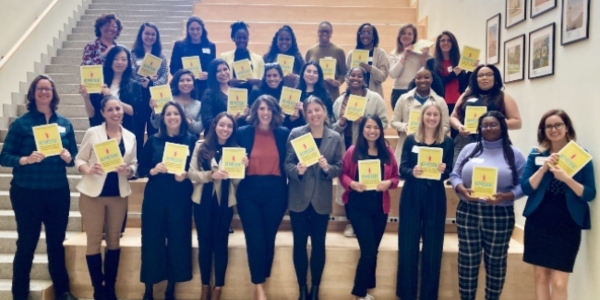 group photo of class around author holding books