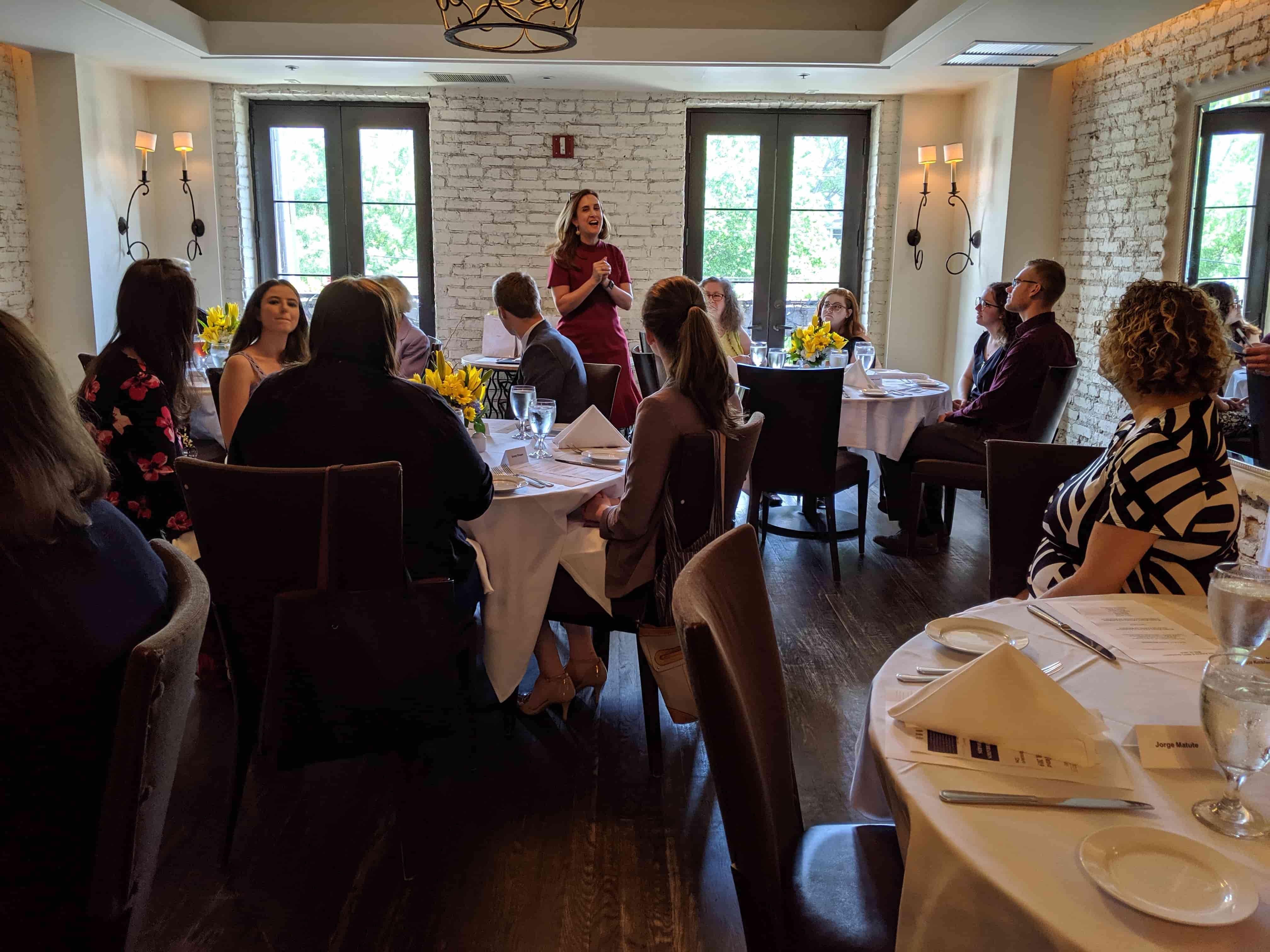 Betsy Fischer Martin addressing the attendees of the graduation lunch event