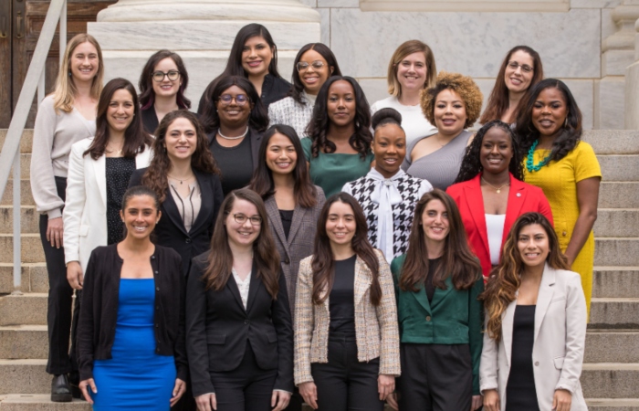 21 women standing on stairs for group photo