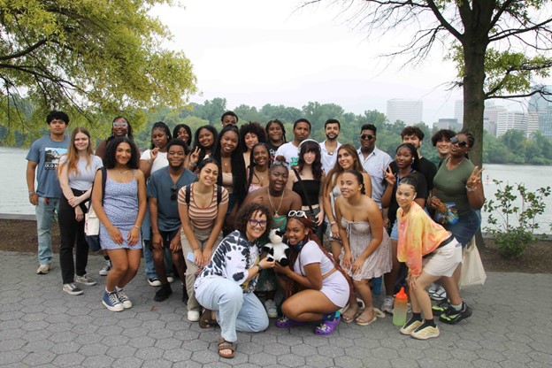 Group of STEP students with a river and skyline behind them.