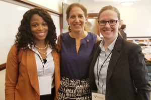 Three woman together at a conference.