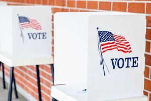 White ballot boxes with American flags.