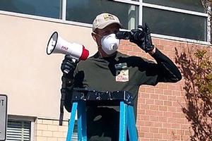 Man on a ladder with a megaphone