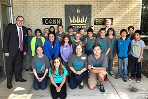 Kevin and elementary school students at a local musical instrument manufacturer